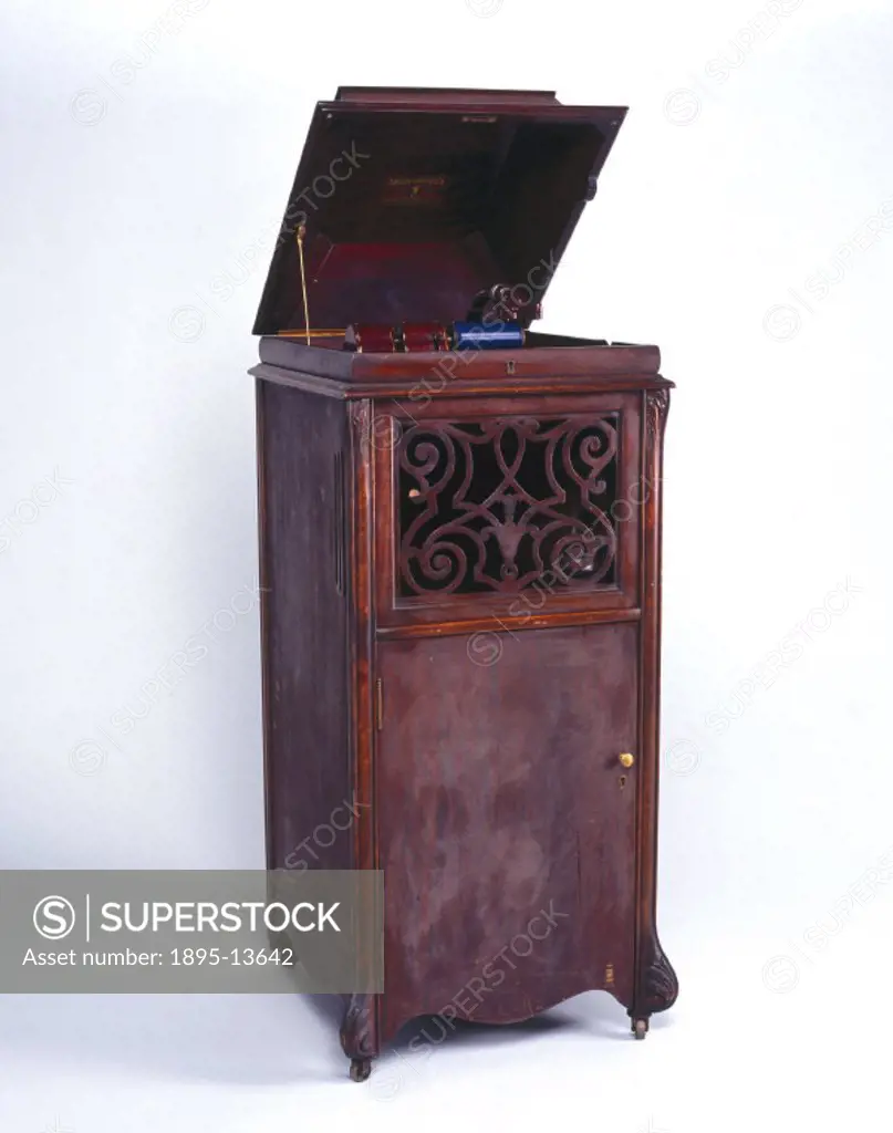 Model A phonograph, contained in an upright floor-standing cabinet. It has four drawers which each hold twenty-five cylinder boxes in clips. The horn ...