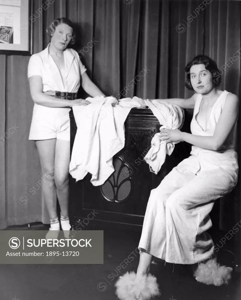 The women are wearing clothes made from new packing cloth. Photograph by Woodbine taken at the HMV Gramophone Works in Oxford Street in London.
