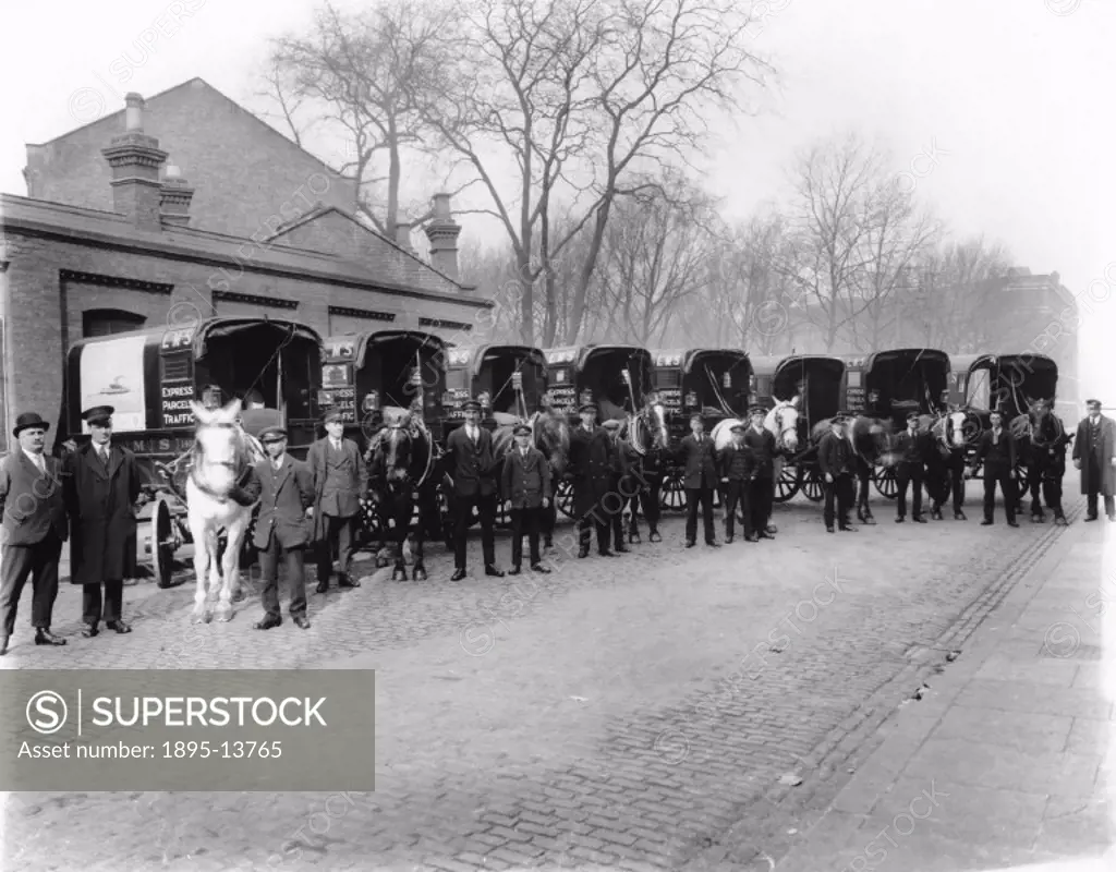 Horse-drawn delivery vans used for the London, Midland and Scottish (LMS) express parcels traffic, lined up with their drivers at Euston, c 1926.