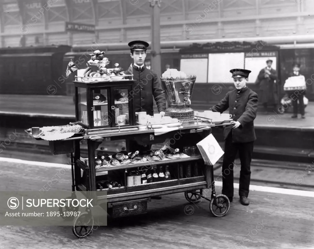 The trolley is on the station platform and is loaded with drinks, sandwiches, fruit and tea- making equipment.