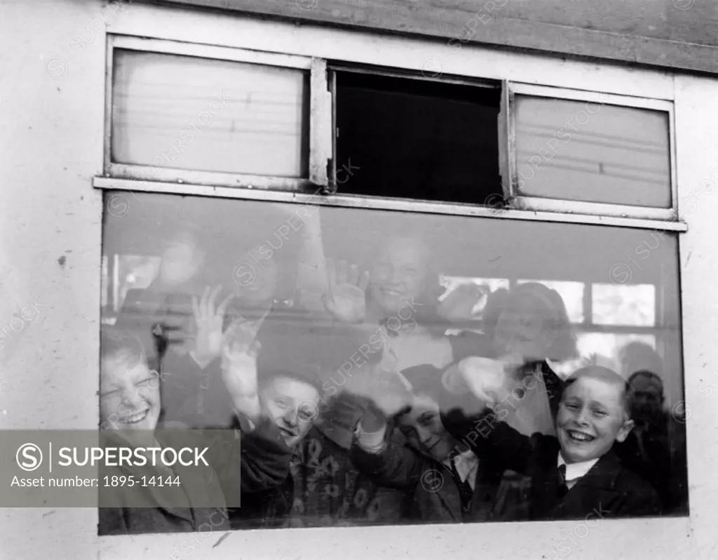 Pupils in the train waving through the window as it is about to leave Shenfield Station, Norfolk.