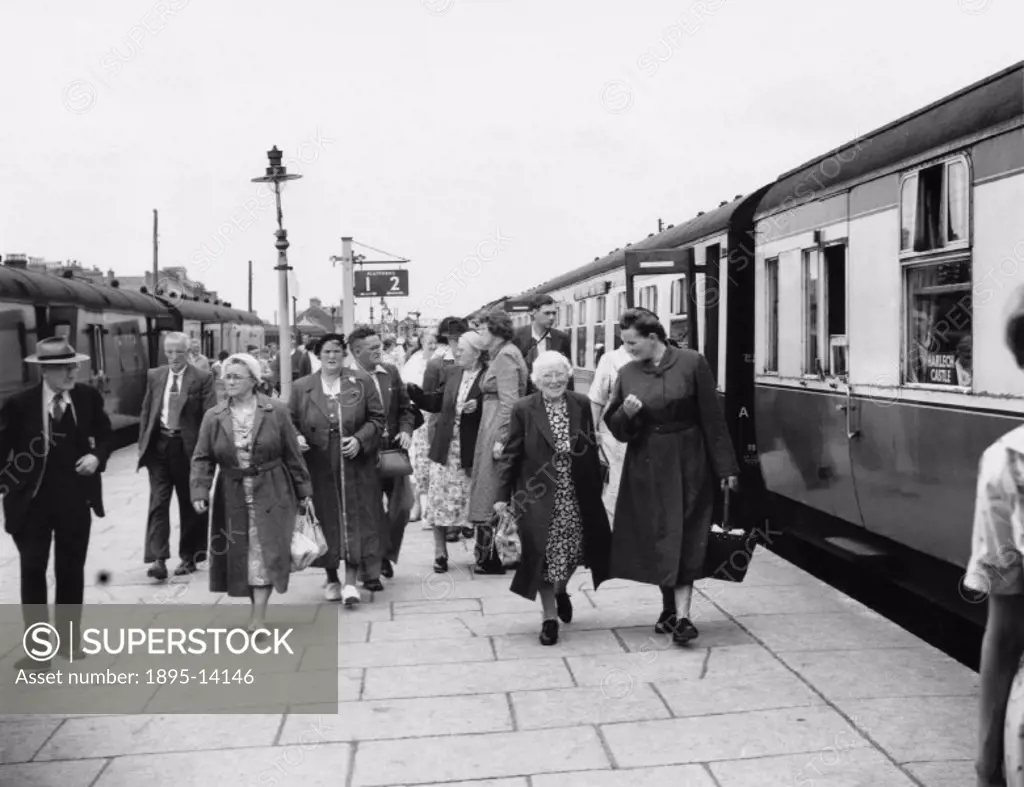 Passengers alighting from the ´North Wales Land Cruise´ train at Barmouth. A scene from the British Transport Films filmstrip ´North Wales Land Cruise...