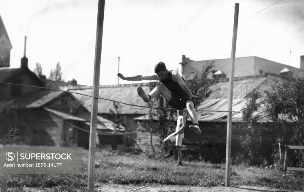 High jumper in action, c 1920s.