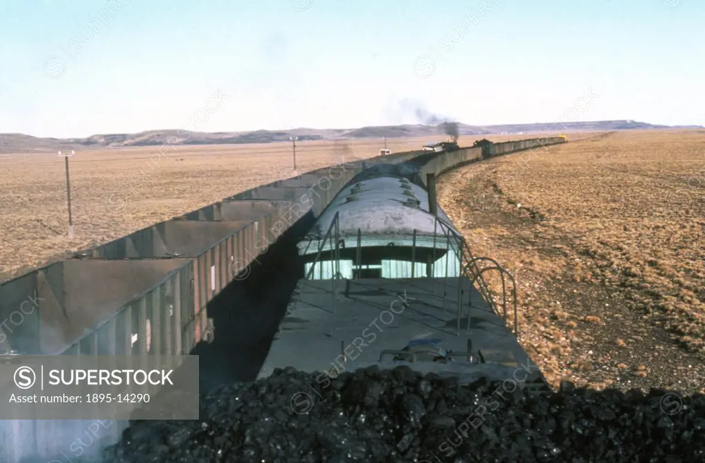 The view from the top of a coal train heading for Rio Gallegos in Patagonia, Argentina as it passes a train of empty wagons heading for the mine at Ri...