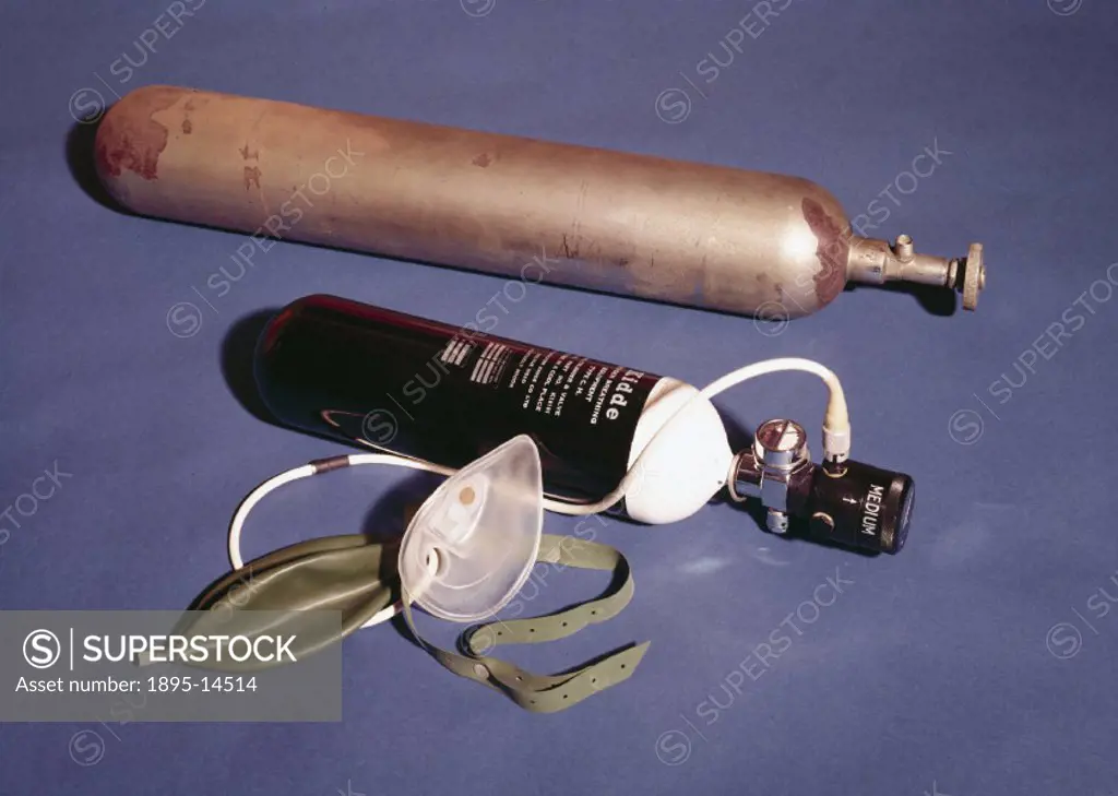 Oxygen cylinder from the British 1922 Everest Expedition, shown with a modern oxygen cynlinder and breathing mask, similar to those used in the succes...