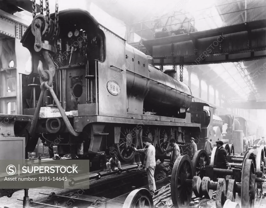 View of the Horwich Works Erecting Shop of the Lancashire & Yorkshire Railway. ´Fitting wheels to a 0-6-0 steam locomotive, No 392´. Photograph by an ...