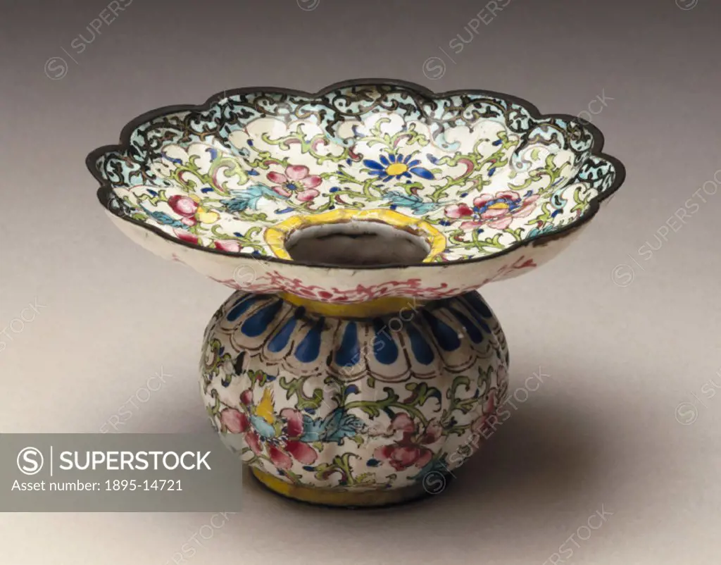Enamelled metal, decorated with a multicoloured floral pattern. Its globular base is surmounted by a broad brim. Spittoons were used to collect spitt...