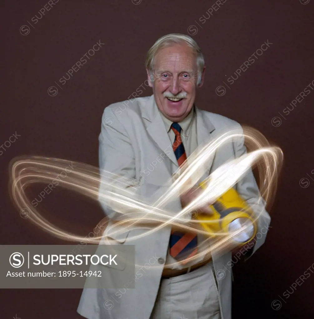 Trevor Baylis (b 1937) shown with his wind-up torch. Baylis invented the world´s first clockwork radio. It has three bands (MW, SW and FM) and needs n...