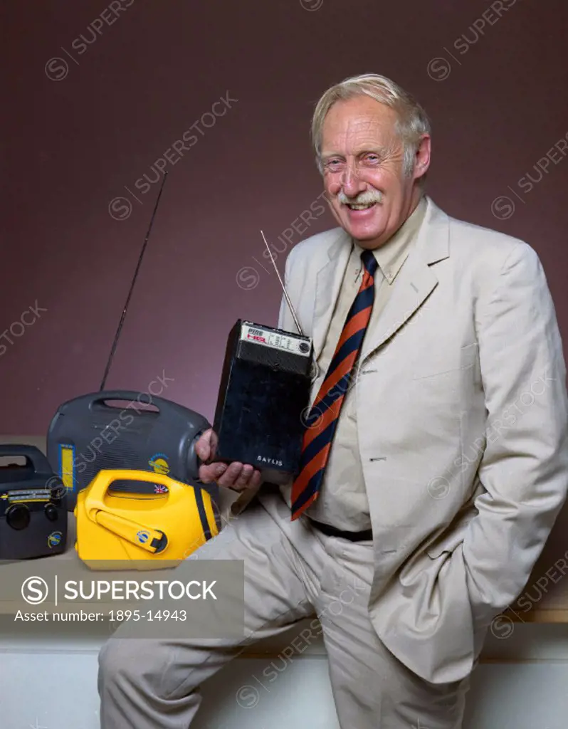 Trevor Baylis (b 1937) shown with a range of wind-up radios, including the very first experimental machine, which he is holding. Baylis invented the w...