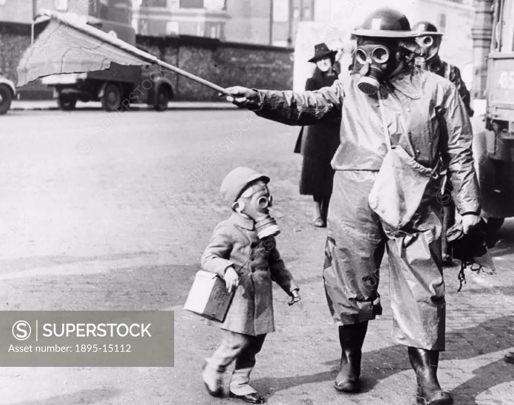 Child and warden wearing their gas masks during first gas exercise in London, on 27 March 1941. ´London´s first anti-gas test. All measures against ga...