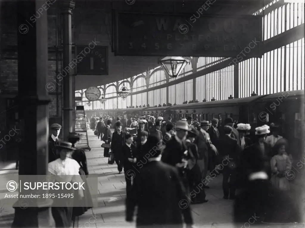 Railway travellers on a platform, c 1900s.