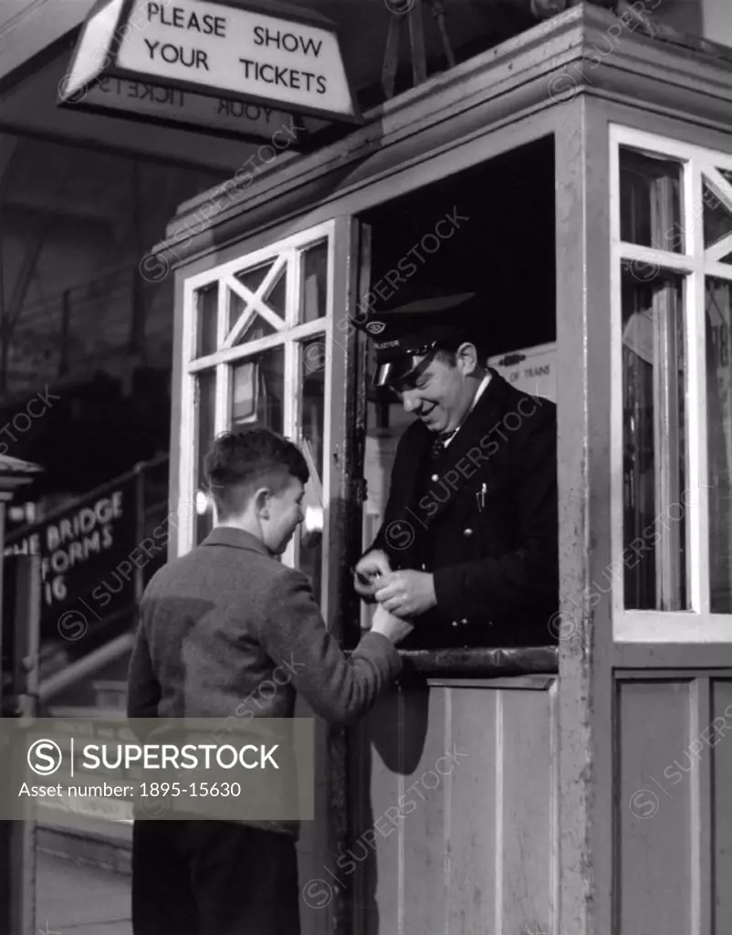 Small boy at York station having his ticket clipped at the platform barrier by a station collector. British Transport Film photograph.