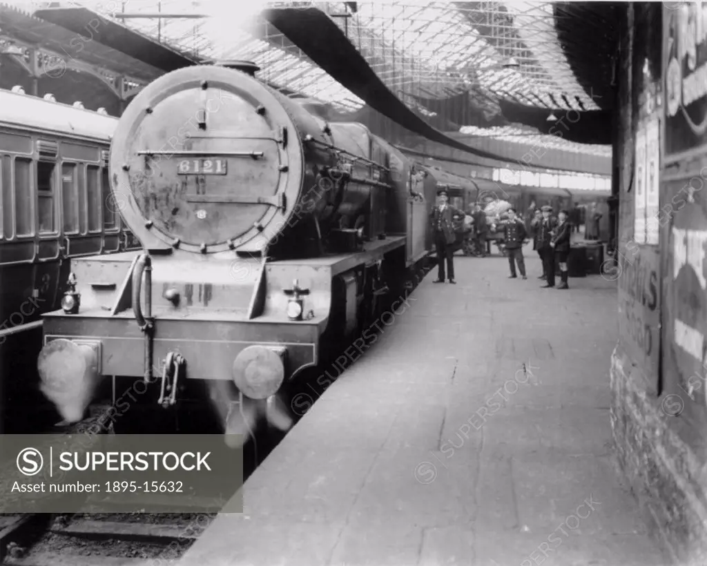 Mail train, hauled by LMS ´Royal Scot´ class 4-6-0 steam locomotive No 6121 ´HLI´, awaiting departure from Euston. Postal workers loading mail bags ju...