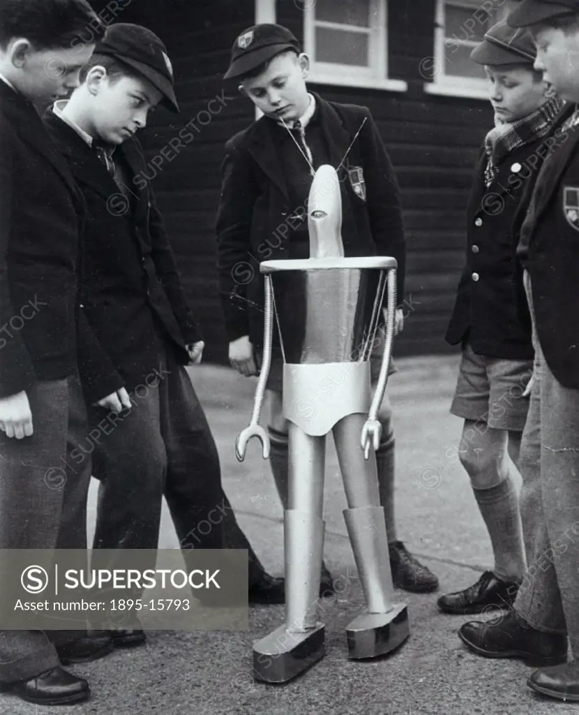 London schoolboys interested in, and perhaps a little quizzical about, a wonderful model spaceman robot, ´Mr Robotham´, which really walks. It will b...