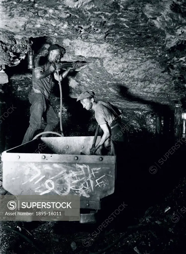 ´To clear a passage through rock or stone, one man drills whilst his mate loads the debris into trucks. Compressed air for the drills is brought along...