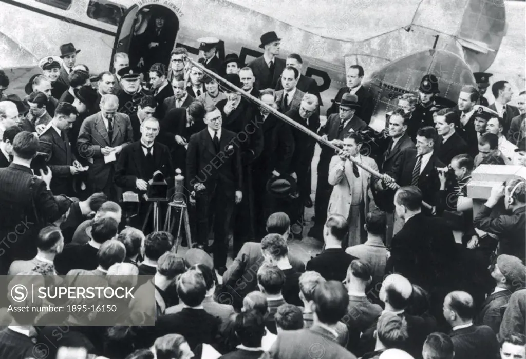 Neville Chamberlain (1869-1940) returning from Munich, Heston Airport after discussing European peace with Hitler.
