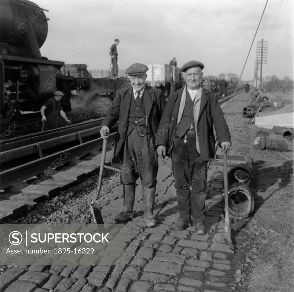 Two railway workers pose for a photograph beside the tracks on Hest Bank Water troughs between Lancaster and Carnforth.