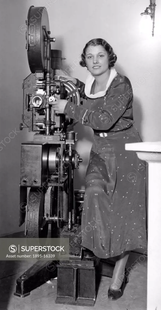 Woman model demonstrating cine projector at exhibition, 30 May 1932.Photograph by George Woodbine.