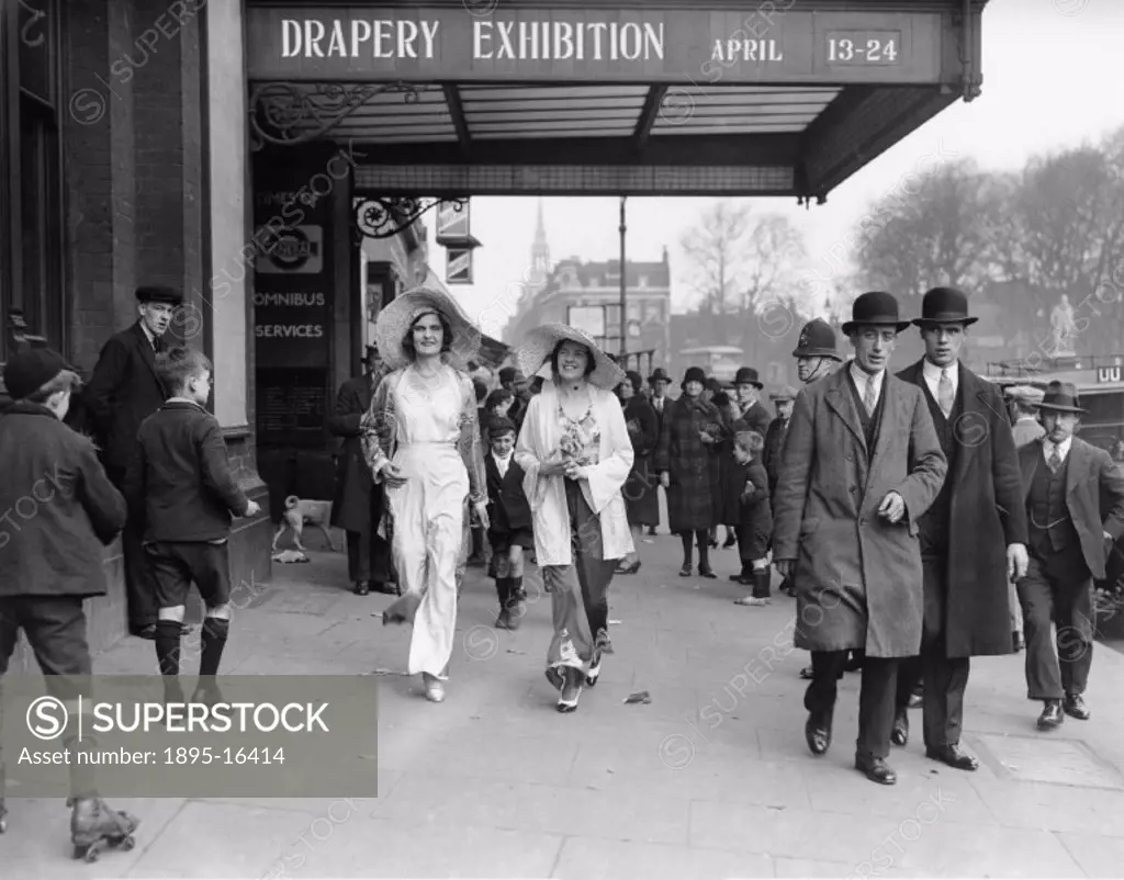 Models wearing beach costumes walking in the street outside the Drapery Exhibition at the Agricultural Hall, Islington, on the13 April 1931. Photograp...