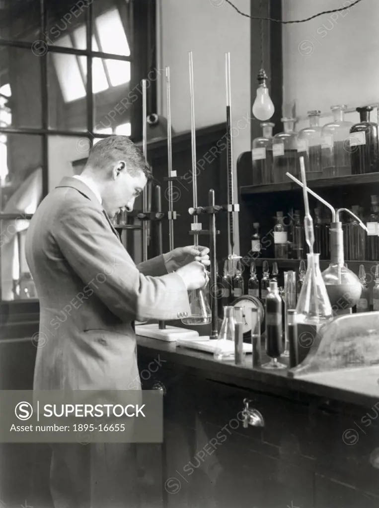 Conducting a volumetric analysis experiment in a National Oil Ltd laboratory in Wales, 17 July 1931. Photograph by James Jarche (1891-1965).