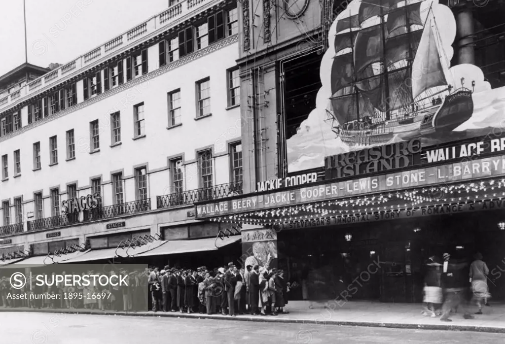 Queueing outside the Empire cinema to see ´Treasure Island, London, 1934.Crowds outside the Empire, Leicester Square, London, waiting to see the film...