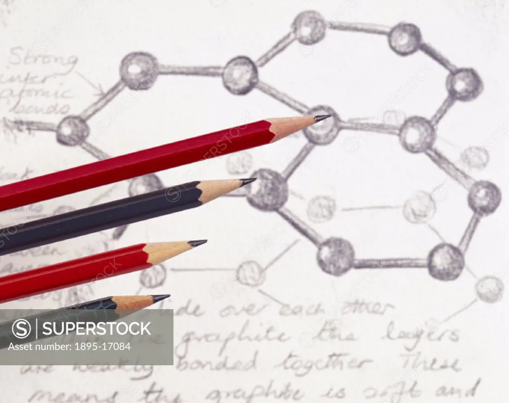 Carbon atoms drawn in graphite, with pencils lying on top of the paper. Graphite is an allotrope of carbon in which each carbon atom is linked to thre...