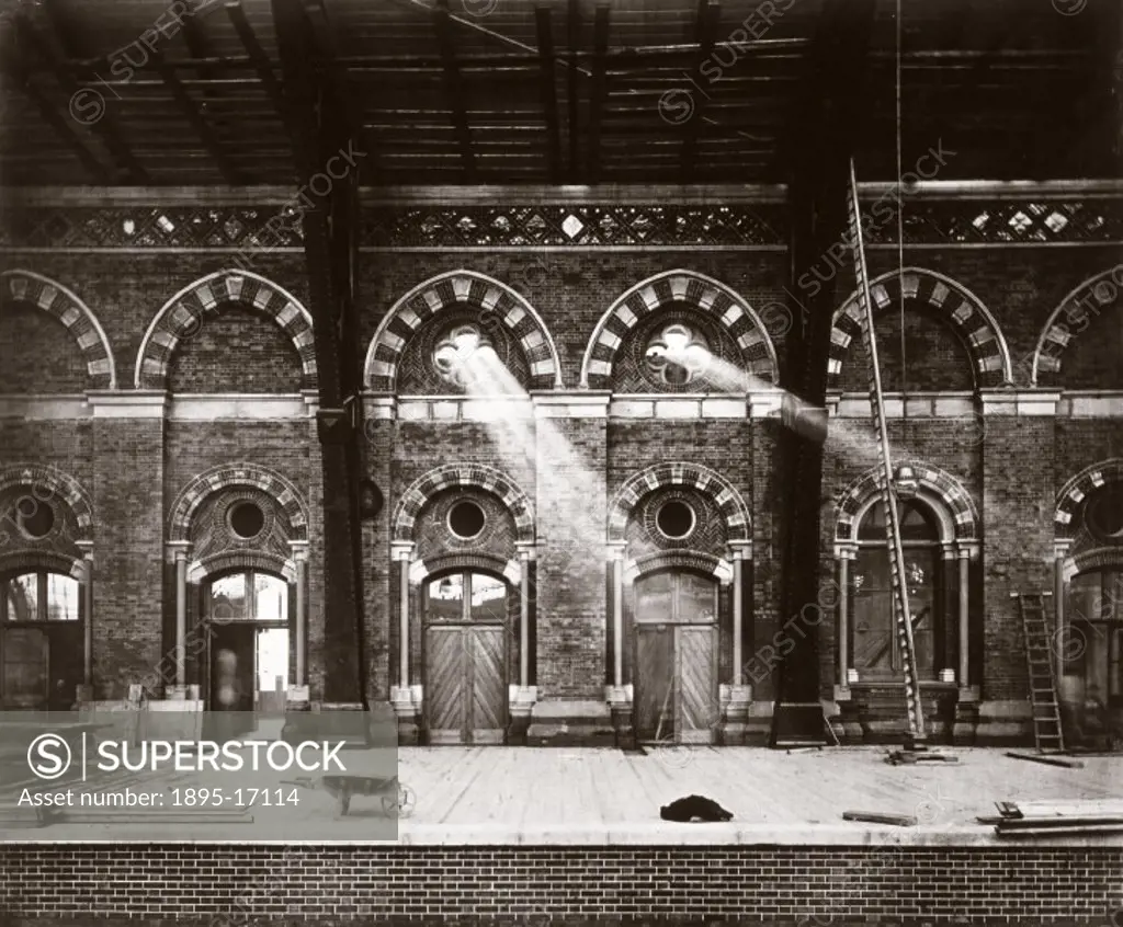 Photograph produced for the Midland Railway showing shafts of light shining through the Gothic windows of St Pancras Station as the building of the st...