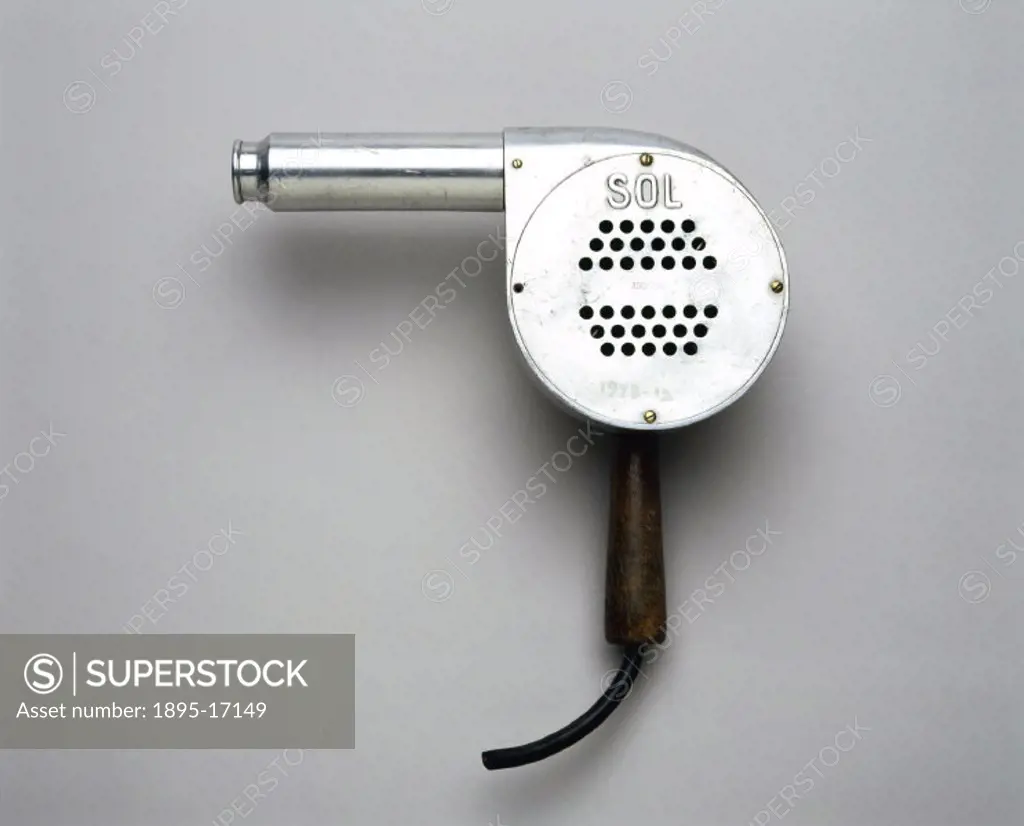 This early electric fan-driven hairdryer is simple in design and has two heat settings. It was generally used by middle class households in the 1920s....