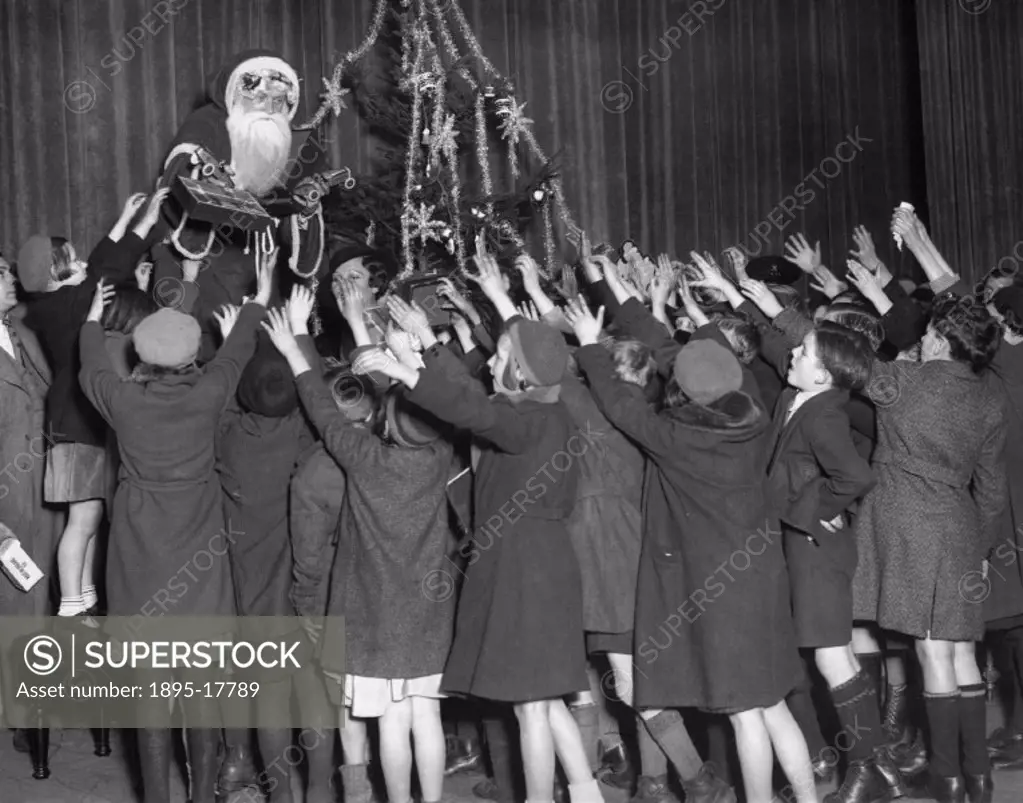 Father Christmas distributes toys to poor children of the district at the Stoeborn Empire.