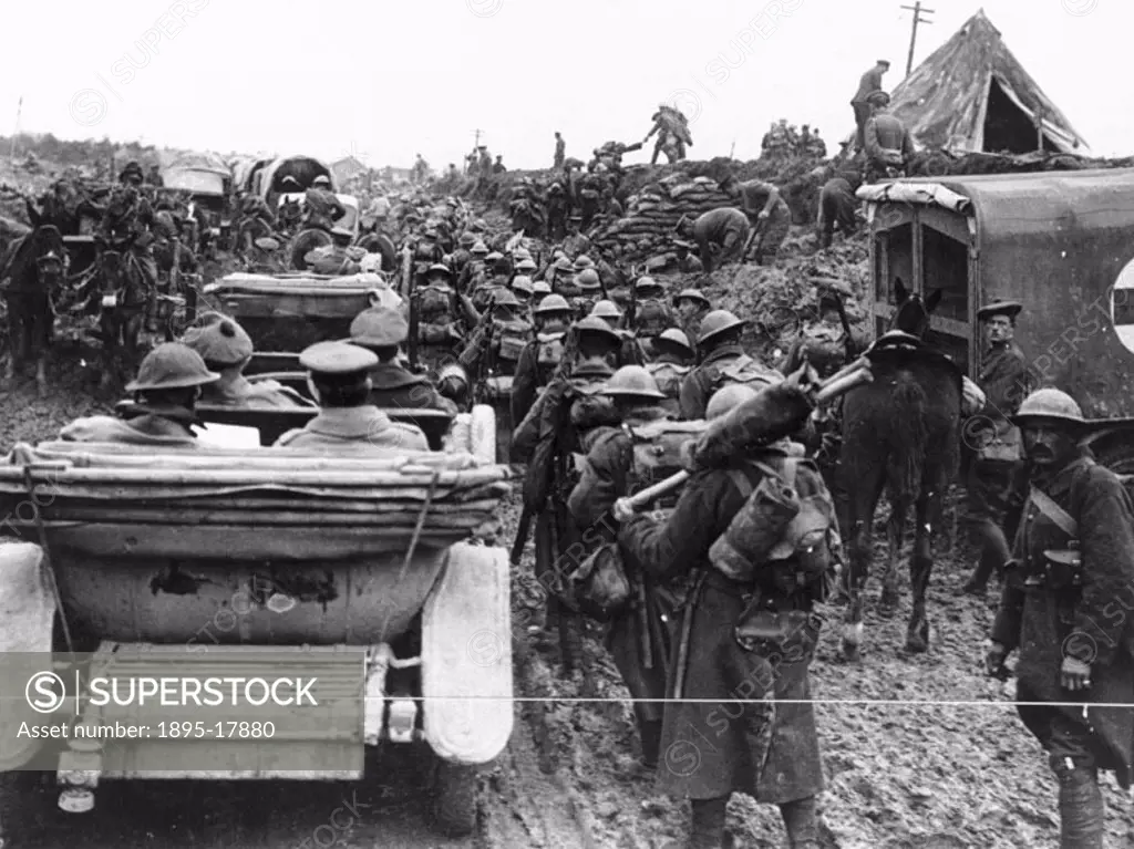The muddy road, near Fricourt, is full with staff cars, mule-limbers, lorries, ambulances, infantry marching and pioneers road widening. During the fi...