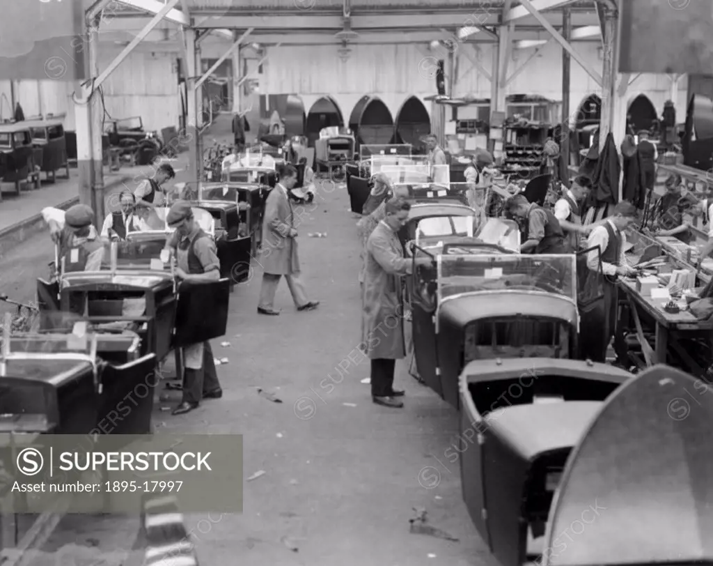 Photograph by Harold Tomlin showing workers assembling cars at Lanchesters factory in Coventry, West Midlands.
