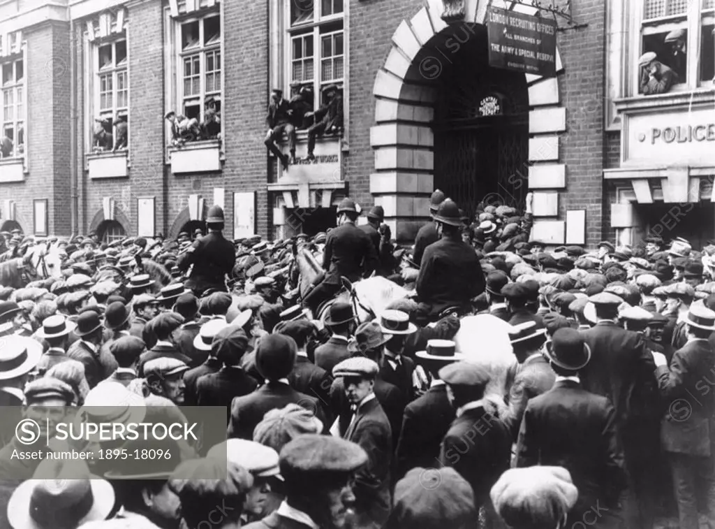 Crowds outside a London recruitment office waiting to enlist following the outbreak of the First World War. Photograph reproduced in 1939 following th...
