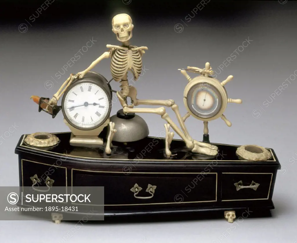 A Victorian alarm clock mounted on a coffin with a skeleton.