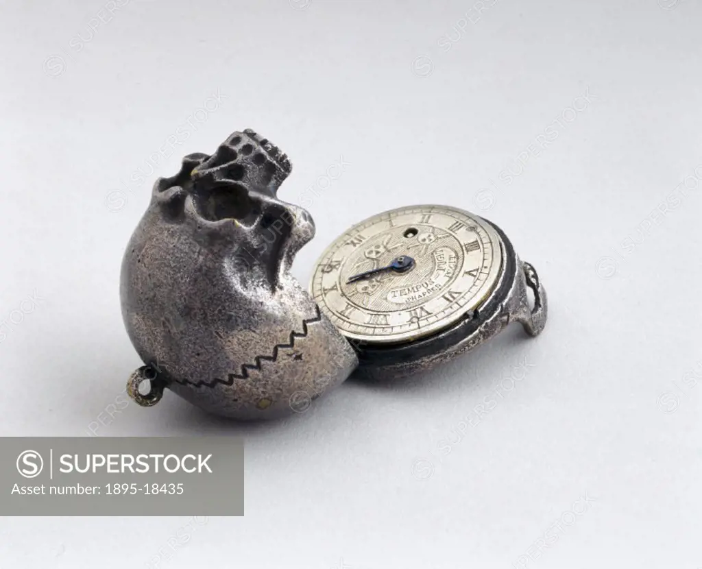 This silver model of a human skull opens up to reveal a pocket watch inside.