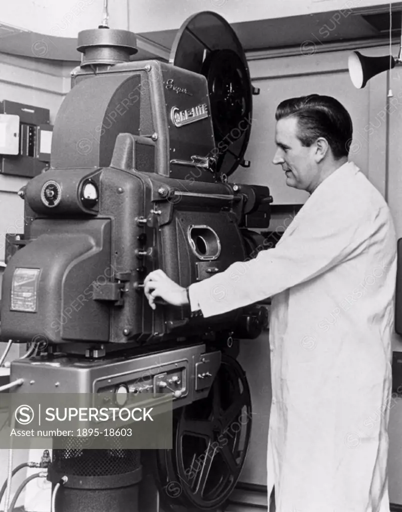 House engineer with Cinemeccanica projector, Odeon Cinema, c 1950s.House engineer, Jack Isaac, with one of the giant Cinemeccanica projectors at the M...