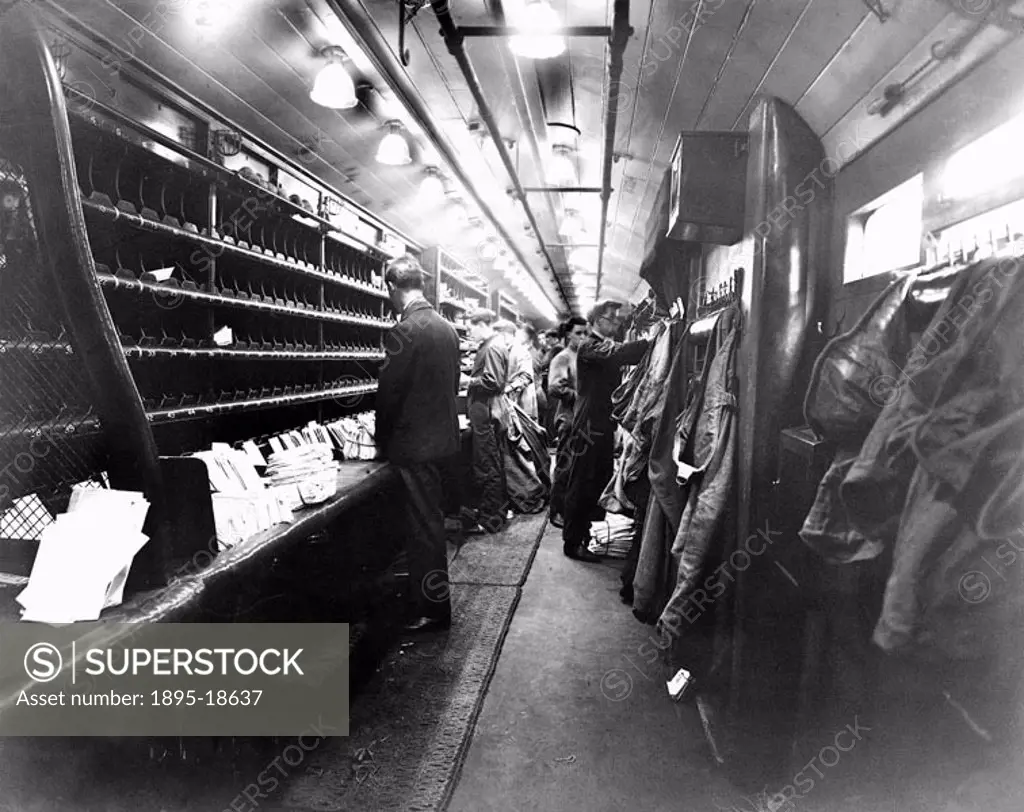 Postal workers sorting mail on a London, Midland & Scottish mail train.