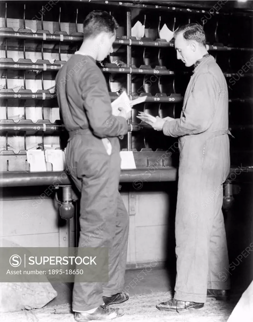 Postal workers sorting mail on a London, Midland & Scottish mail train.