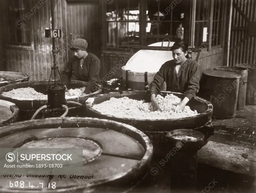 Women workers with their hands in nitration pans. A huge cordite explosive factory was built at Gretna in 1915, providing employment for over 9000 wom...