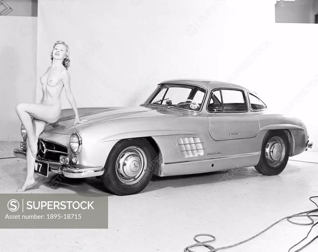 Nude model and Mercedes wing_door car, c 1961. Model reclining on a Mercedes. Photograph by Zoltan Glass 1903_1982.