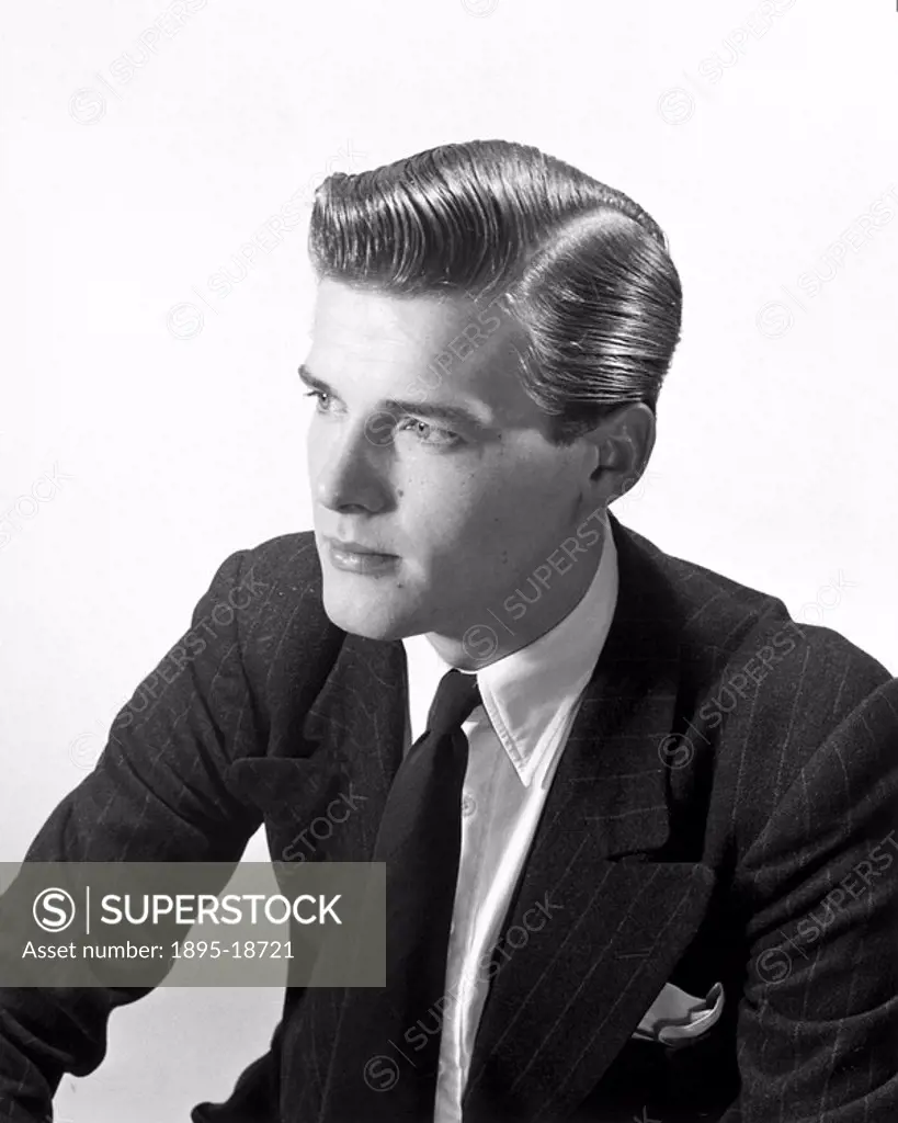 Roger Moore, Silvercrin advert, c 1950. British actor Roger Moore, who later played James Bond, in an advertisement photograph for a hair product. Pho...