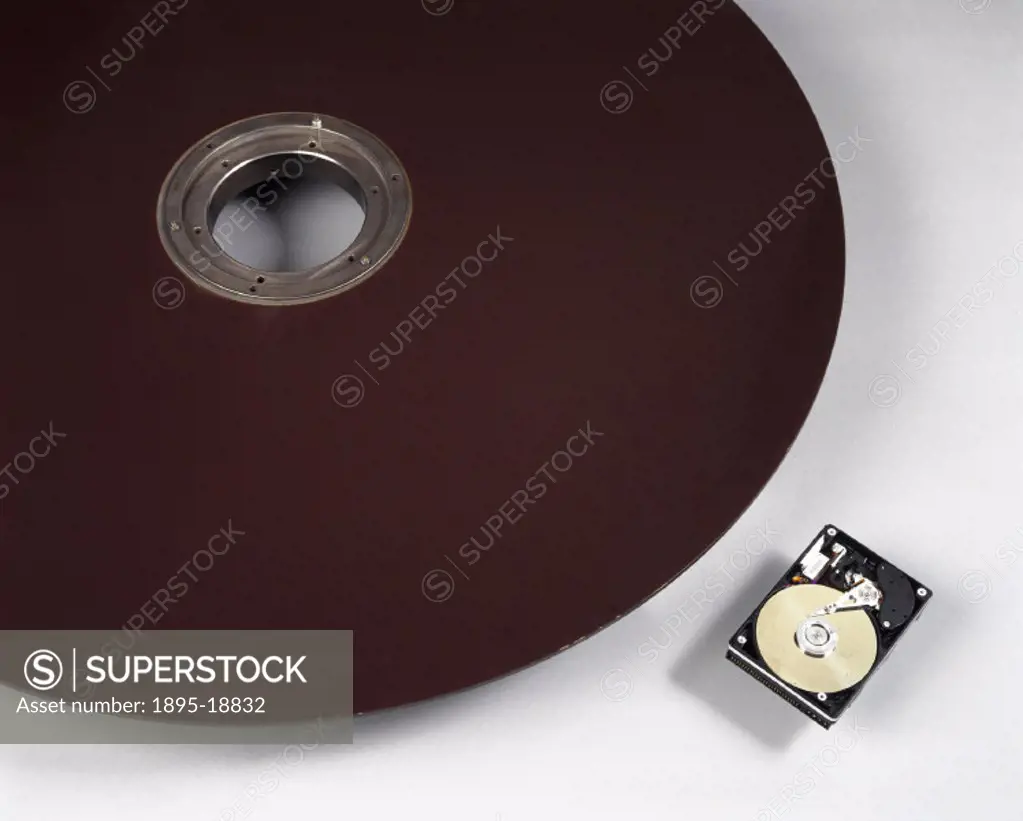 This photograph startlingly demonstrates the impact of miniaturisation on computer technology. The large disc is from an IBM system of 1984 and can ho...