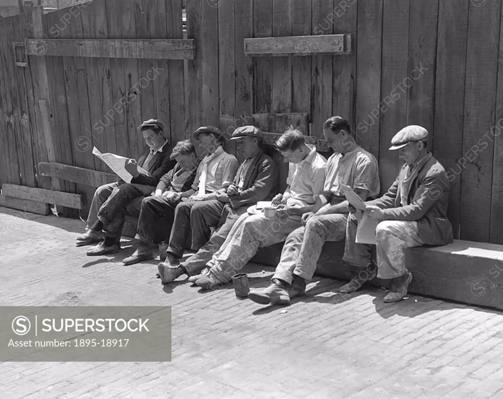 Construction workers relaxing, London, 16 June 1932  Men working on the construction of the Shell Building on the South Bank, sitting in the shade dur...
