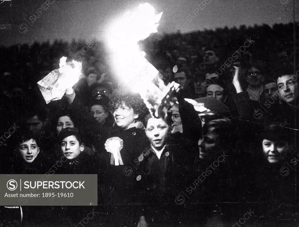 Spectators holding lit newspaper flares, 8 January 1956  ´The light became so bad in the second half of the Charlton vs Burton match that spectators l...