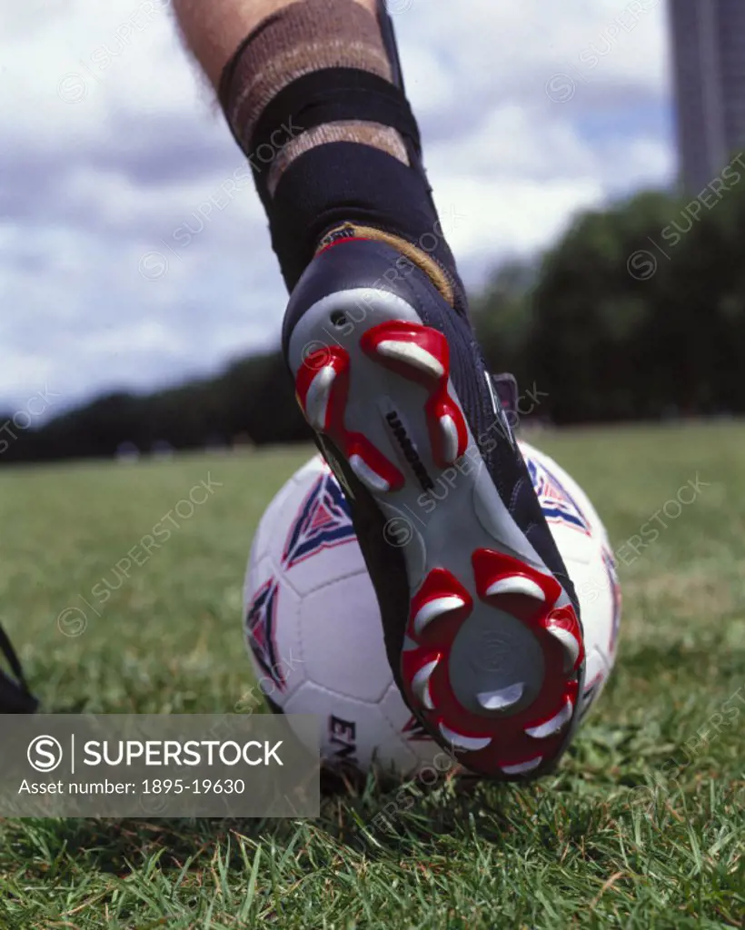 A football boot about to strike a ball, October 2000.