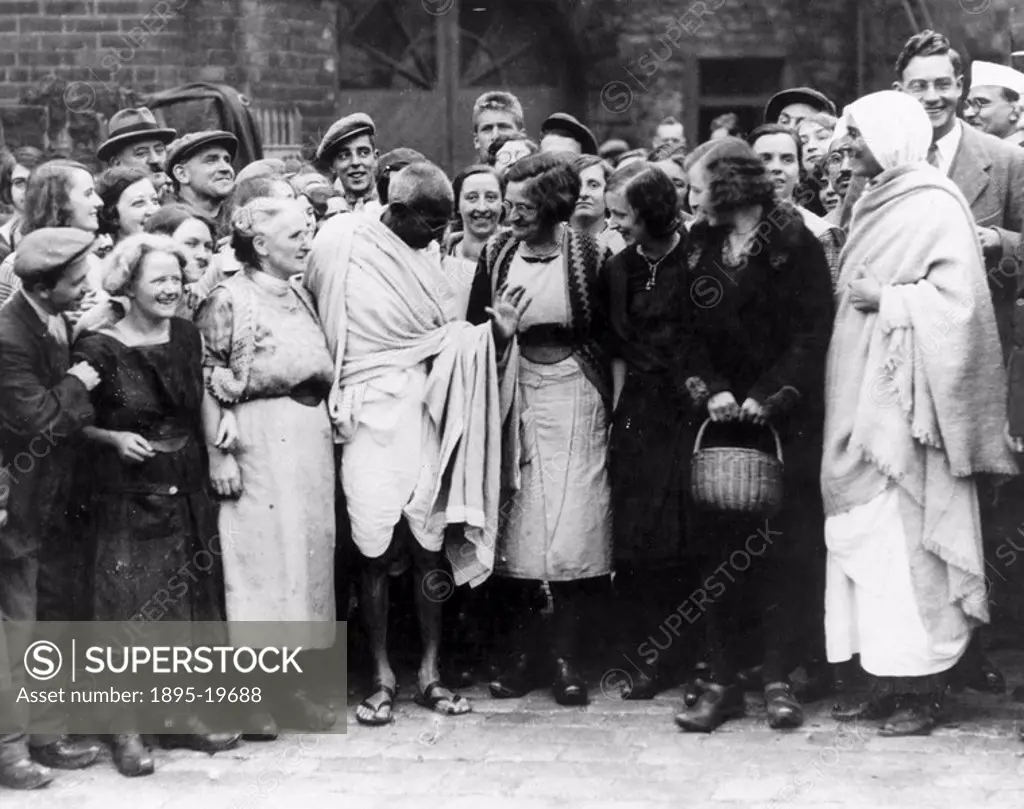 Mahatma Gandhi on an official tour, England, 1931. Mahatma Gandhi talking to a group of women in a crowd during an official tour. Gandhi 1869_1948 is ...