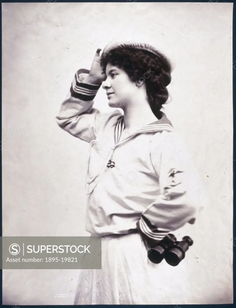 Woman posing in a sailor suit holding a pair of binoculars, c 1880-1899.