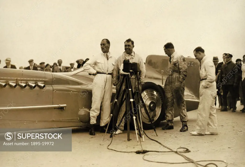 Photograph showing Campbell (1885-1949) and his Rolls-Royce powered racing car the ´Bluebird´ at Daytona Beach racetrack, Florida. Campbell was the ho...
