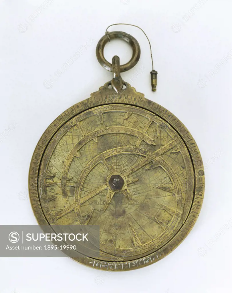 This unsigned brass Islamic astrolabe is from the Middle East and is probably of Syrian origin. An astrolabe is in essence a model of the universe tha...