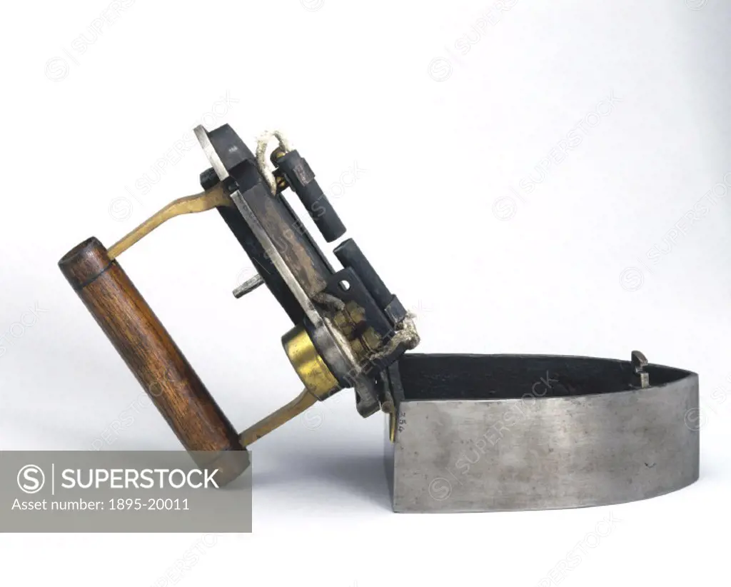 This early smoothing iron of unusual construction used an electric spark as its heat source. The soleplate is heated by passing a current across carbo...