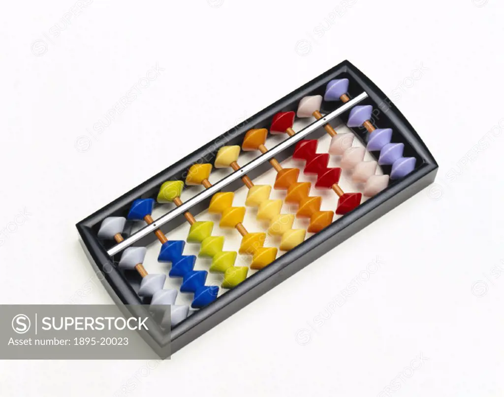 A Japanese abacus with coloured plastic beads in a cardboard case. The soroban has 1 bead above the bar and 4 beads below. It is used for calculations...